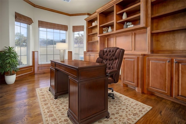 office area featuring light wood-type flooring and crown molding