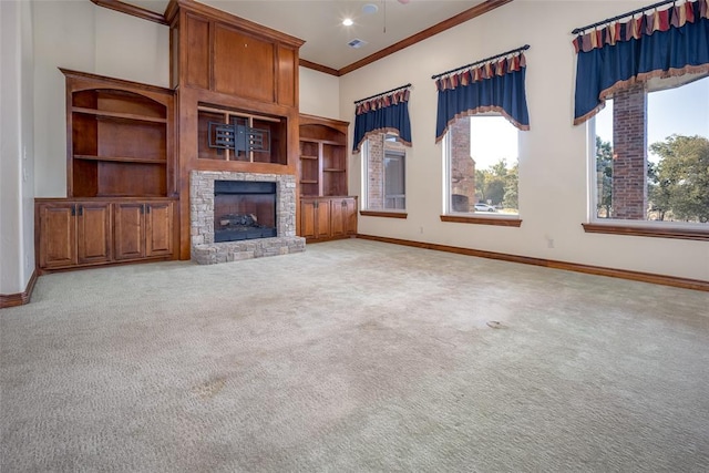 unfurnished living room featuring a fireplace, crown molding, and light carpet