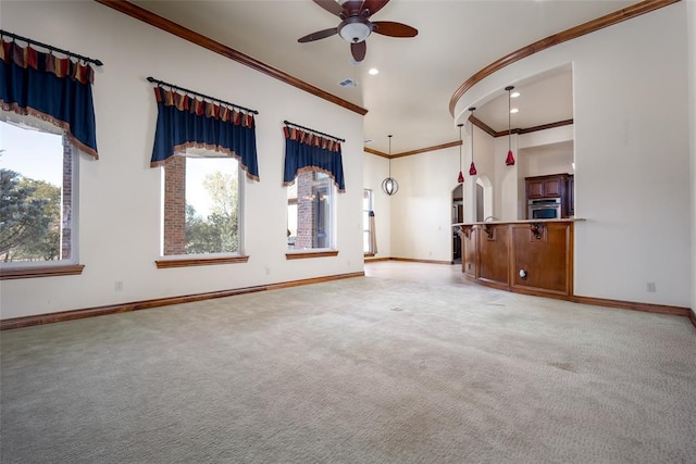 carpeted spare room featuring crown molding and ceiling fan