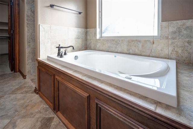 bathroom with a tub to relax in