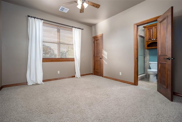 unfurnished bedroom with light carpet, connected bathroom, and ceiling fan