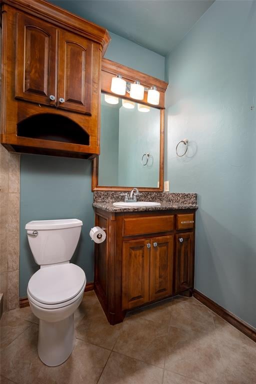 bathroom featuring tile patterned floors, vanity, and toilet