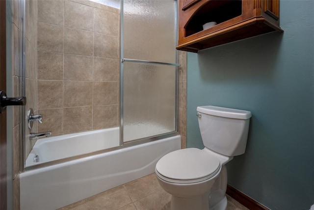 bathroom with tile patterned flooring, toilet, and enclosed tub / shower combo