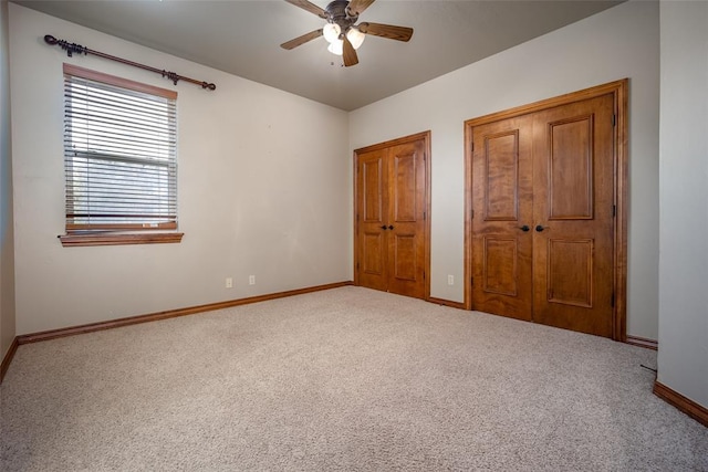 unfurnished bedroom featuring ceiling fan and carpet floors