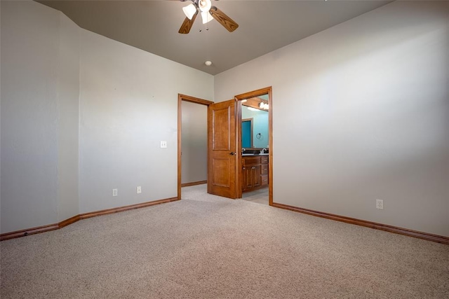 empty room with ceiling fan and light carpet