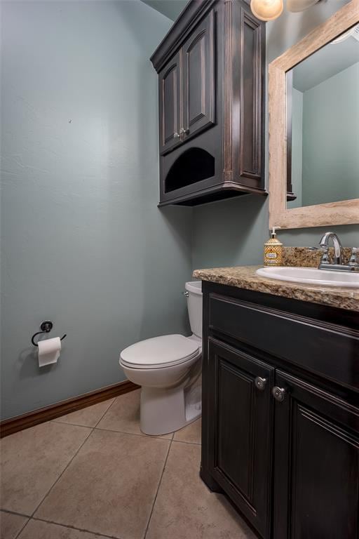 bathroom with tile patterned floors, vanity, and toilet