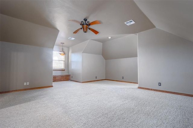 additional living space featuring ceiling fan, light colored carpet, and lofted ceiling