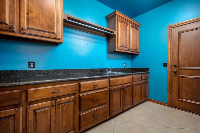 kitchen with light tile patterned floors and sink