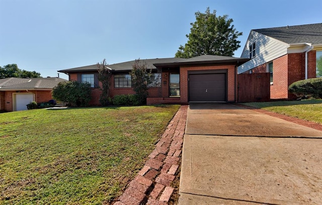 single story home with a garage and a front lawn