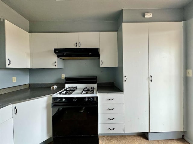 kitchen featuring black gas stove and white cabinetry