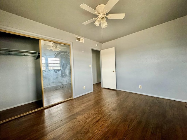 unfurnished bedroom with a closet, dark hardwood / wood-style floors, and ceiling fan