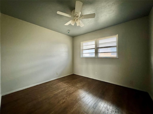 unfurnished room featuring ceiling fan and dark hardwood / wood-style floors