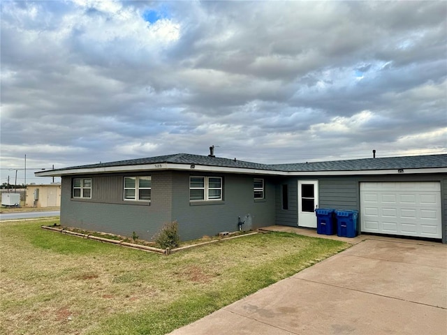 ranch-style home featuring a garage and a front lawn