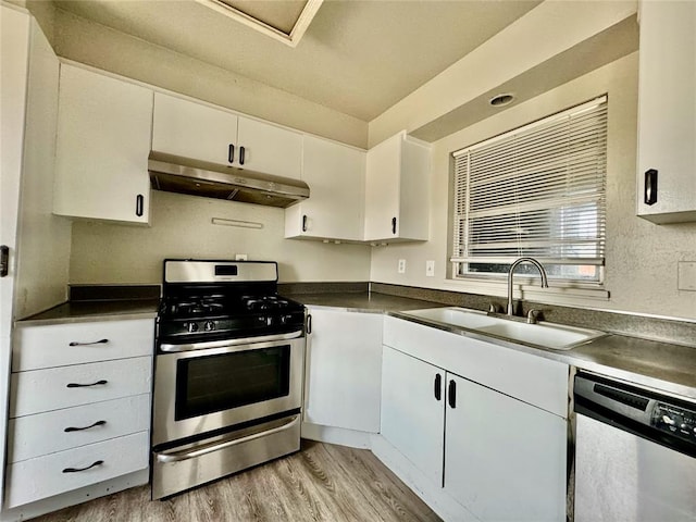 kitchen featuring sink, white cabinets, stainless steel appliances, and light hardwood / wood-style floors