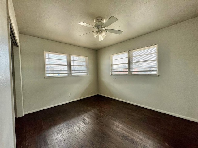 unfurnished bedroom with ceiling fan, a closet, and dark wood-type flooring