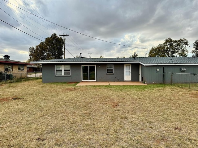 rear view of house featuring a yard and a patio