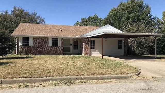 ranch-style house featuring a front yard and a carport