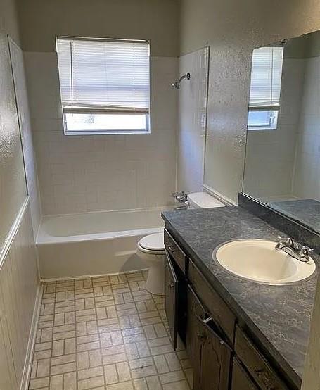 9816 NE 5th St, Midwest City, OK 73130 - full bathroom featuring vanity, bathing tub / shower combination, and brick patterned floors