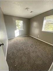 9816 NE 5th St, Midwest City, OK 73130 - carpeted empty room featuring healthy amount of natural light