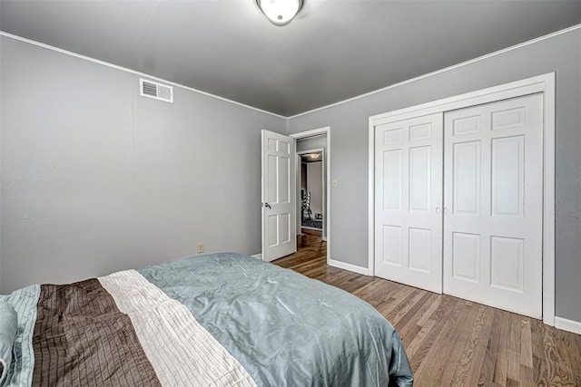 bedroom featuring wood-type flooring and a closet