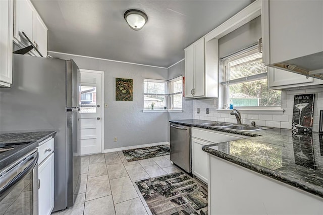 kitchen featuring white cabinets, sink, stainless steel appliances, and tasteful backsplash