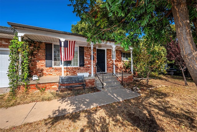 view of front of property featuring covered porch and a garage