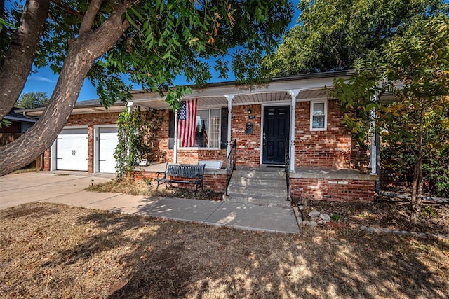 view of front of property featuring a porch and a garage