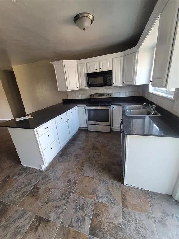 kitchen featuring electric stove, decorative backsplash, sink, and white cabinets