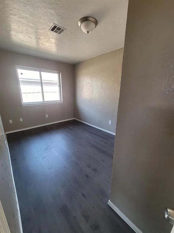 empty room featuring dark hardwood / wood-style flooring