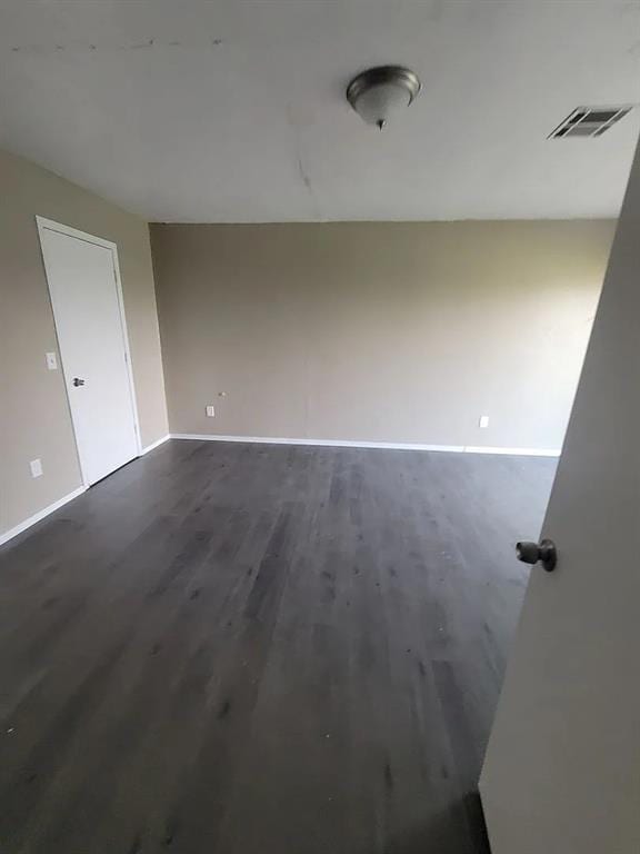 unfurnished room featuring dark hardwood / wood-style floors