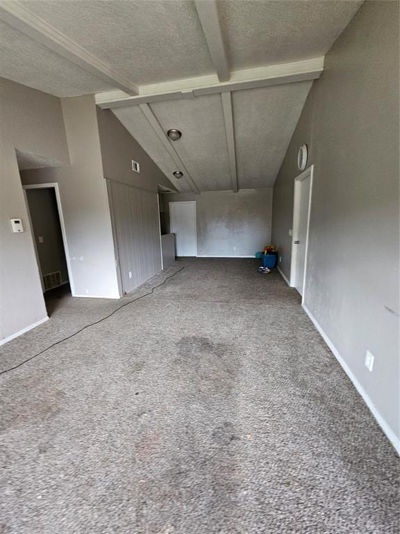 unfurnished living room featuring carpet flooring, beamed ceiling, high vaulted ceiling, and a textured ceiling