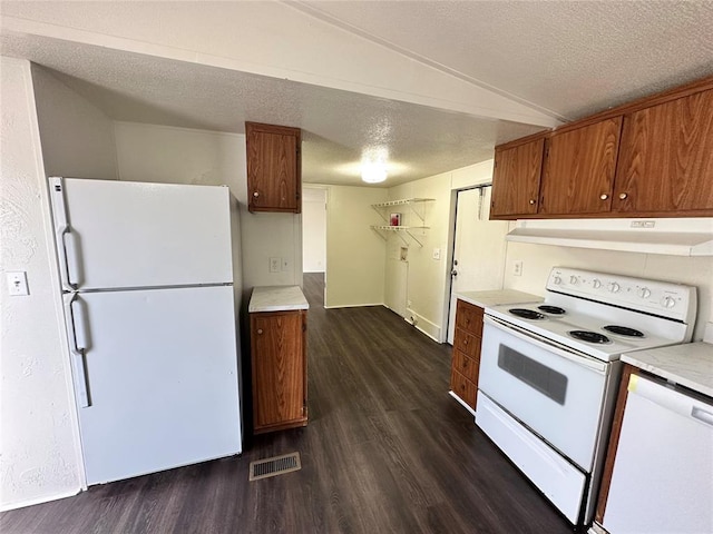 kitchen featuring a textured ceiling, white appliances, vaulted ceiling, dark wood-type flooring, and exhaust hood