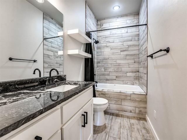 full bathroom with vanity, toilet, and tiled shower / bath