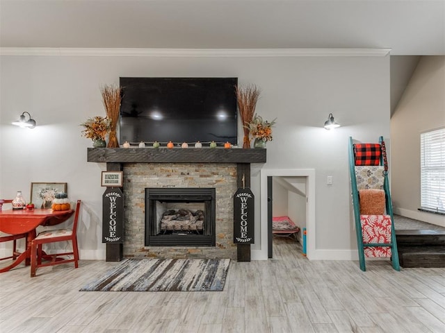 living room with hardwood / wood-style floors, ornamental molding, and a fireplace