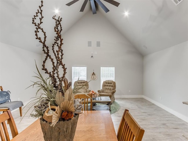 sitting room featuring beamed ceiling, ceiling fan, light wood-type flooring, and high vaulted ceiling