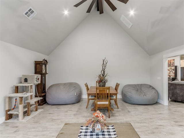 sitting room featuring ceiling fan, high vaulted ceiling, and light wood-type flooring