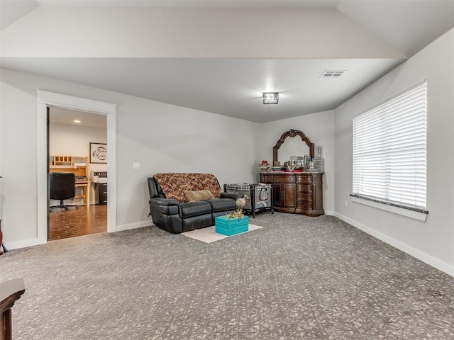 sitting room featuring carpet floors and lofted ceiling