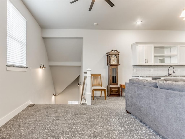 living room featuring ceiling fan and sink