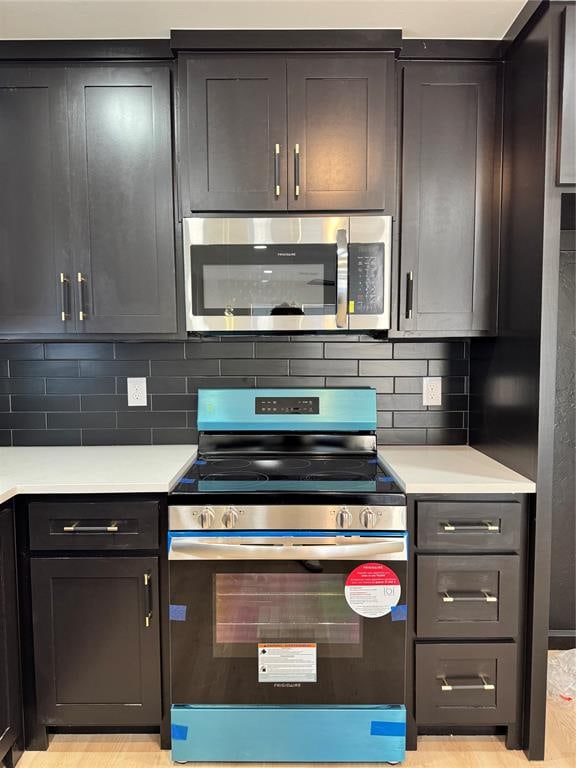 kitchen featuring backsplash and appliances with stainless steel finishes