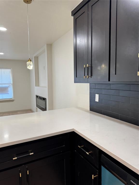 kitchen with beverage cooler, backsplash, and hanging light fixtures