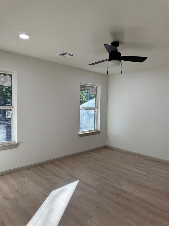 empty room featuring ceiling fan and light hardwood / wood-style floors