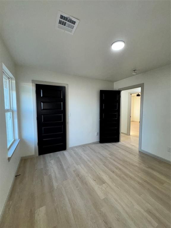 spare room with light hardwood / wood-style flooring