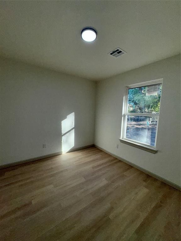 unfurnished room with light wood-type flooring