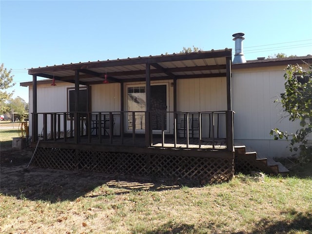 rear view of house featuring a deck