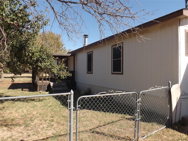 view of side of property with a lawn