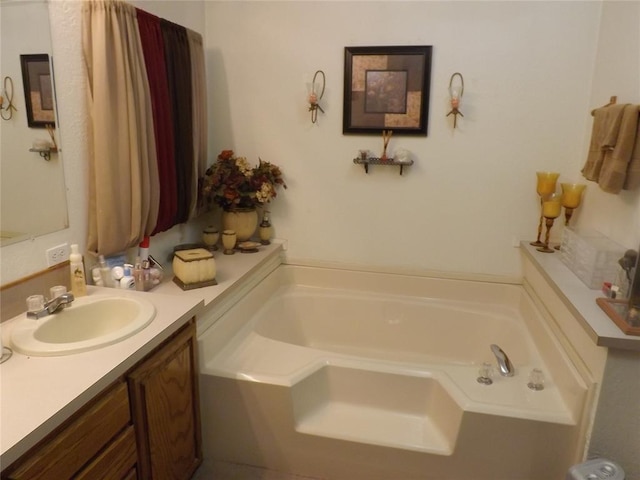 bathroom featuring a tub to relax in and vanity