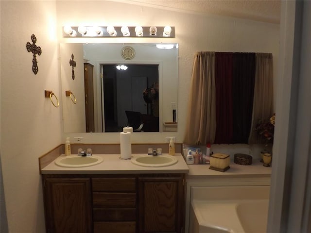 bathroom featuring vanity and lofted ceiling