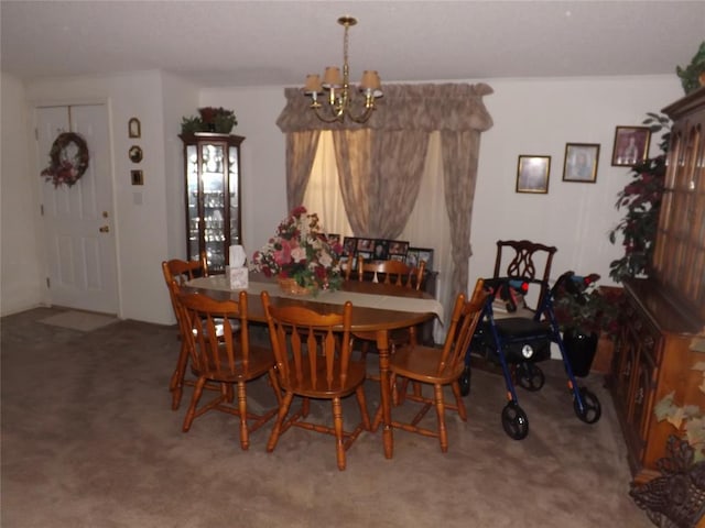 dining area featuring carpet and a notable chandelier