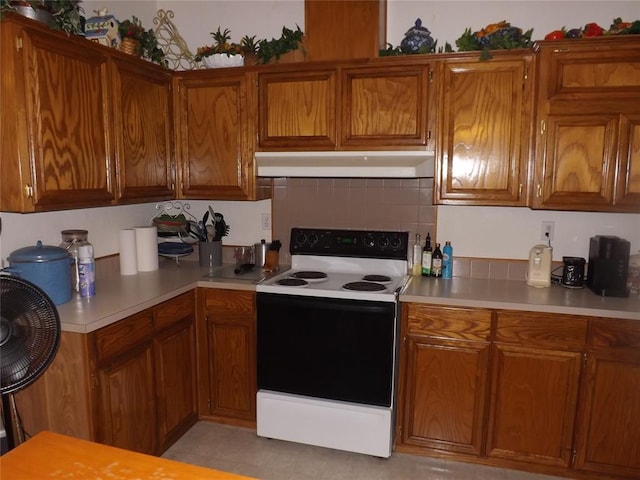 kitchen with electric range and backsplash