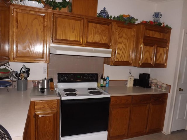 kitchen with backsplash and white electric stove